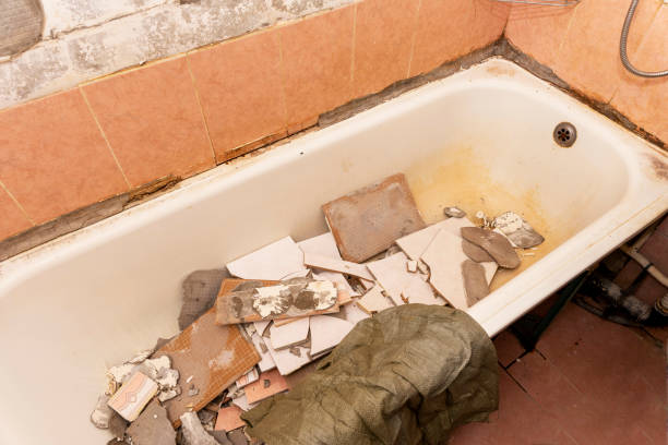 an old dirty shabby bathroom with fallen tiles. repair stock photo