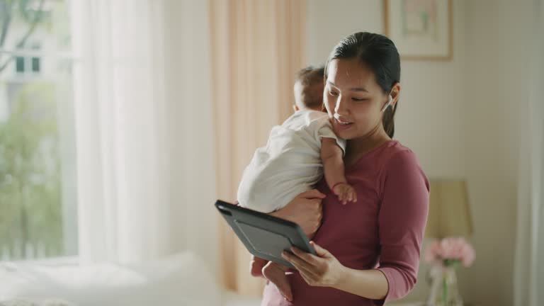 Mother having video call meeting with her baby at home