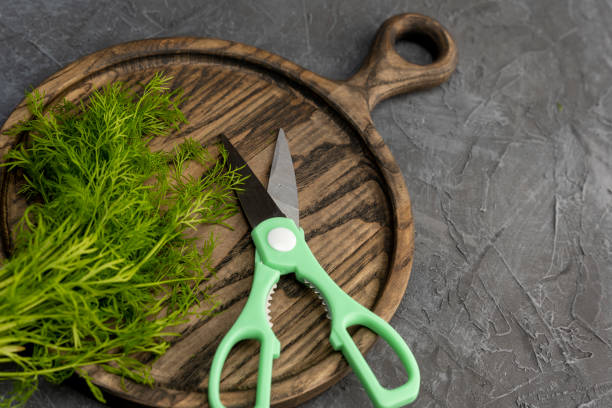 istock kitchen scissors cutting dill in the kitchen on a cutting board 1468237236