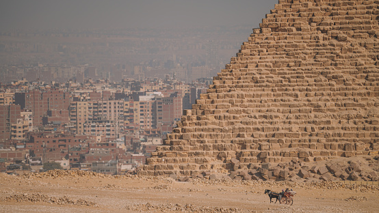 Panoramic view of the pyramids from the Giza Plateau on a sunny day in Cairo, Egypt.  The Pyramid Fields from Giza to Dahshur is on UNESCO World Heritage List\