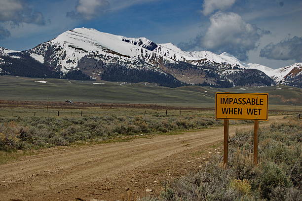 Backroad Sign with Snow-capped Peaks stock photo