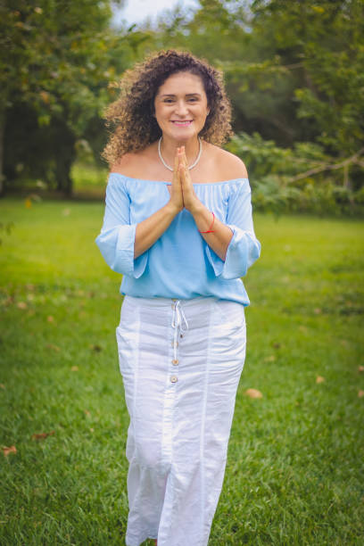istock woman praying in a park 1468239905