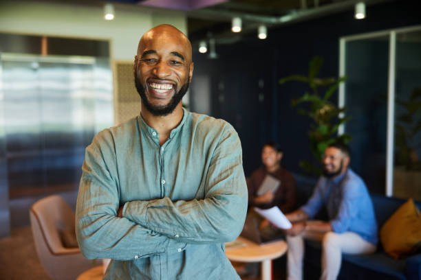 istock Businessman laughing while standing in an office lounge 1468240411