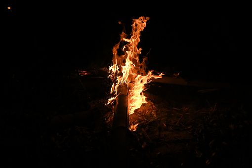 Fire flames on Abstract art black background, Burning red hot sparks rise, Fiery orange glowing flying particles