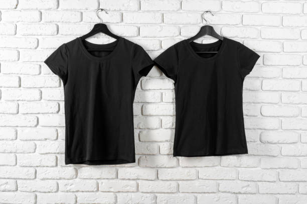 istock Black t-shirt hanging on a hanger against brick wall 1468242595