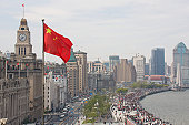 The Bund in Shanghai, China, with Chinese flag