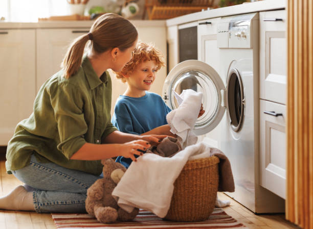 istock Son helping mom to load washing machine 1468243199