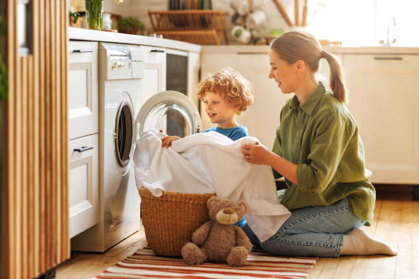 istock Son helping mom to load washing machine 1468243242