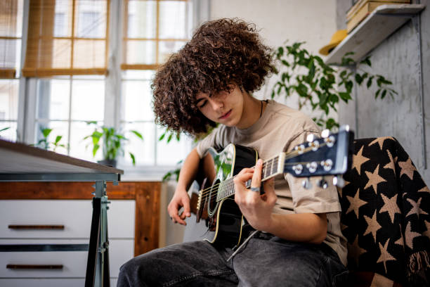 istock Young musician play guitar 1468243297