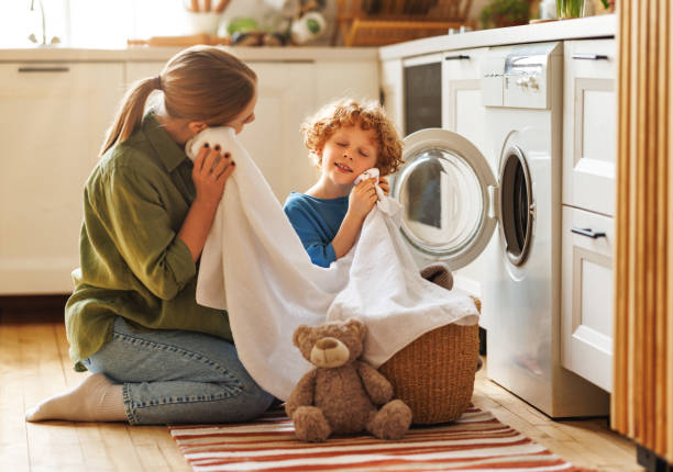 istock Son helping mom to load washing machine 1468243428