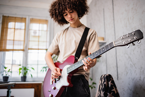 Teenage boy play solo on electric guitar