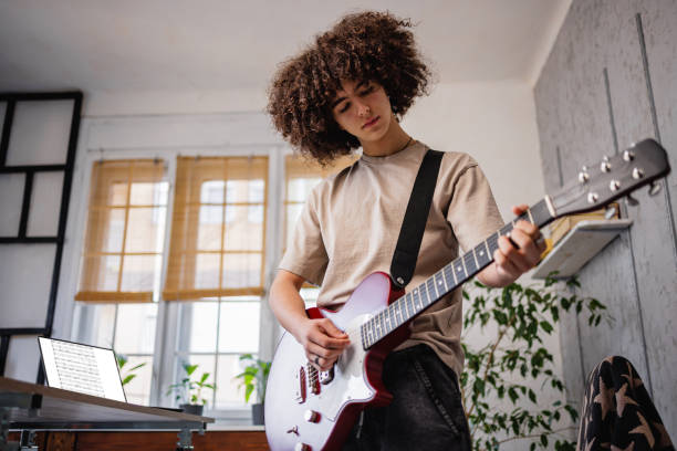 Young musician play electric guitar Young musician play electric guitar one teenage boy only stock pictures, royalty-free photos & images