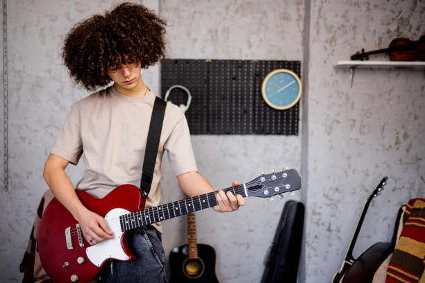 istock Young musician playing electric guitar in music studio 1468243474