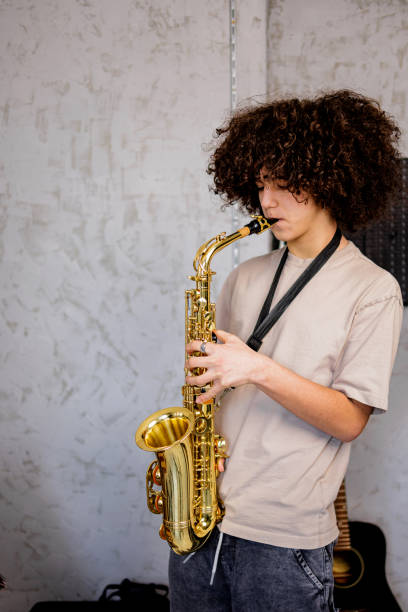 istock Teenager play saxophone at home 1468243673