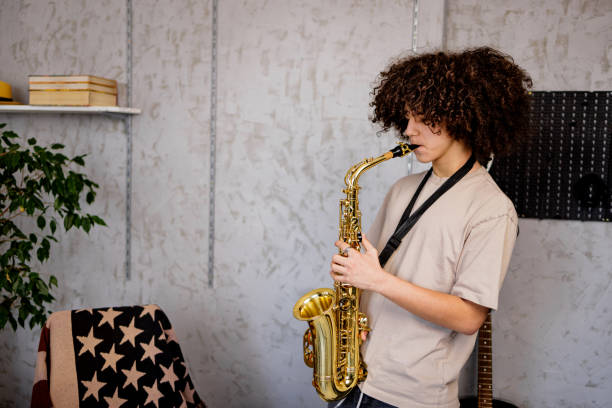 istock Teenager play saxophone at home 1468243679