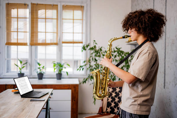 istock Boy play saxophone at home 1468243690