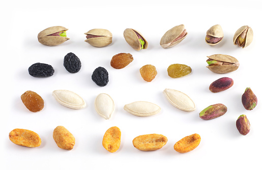 Dried apricots and nuts on white background