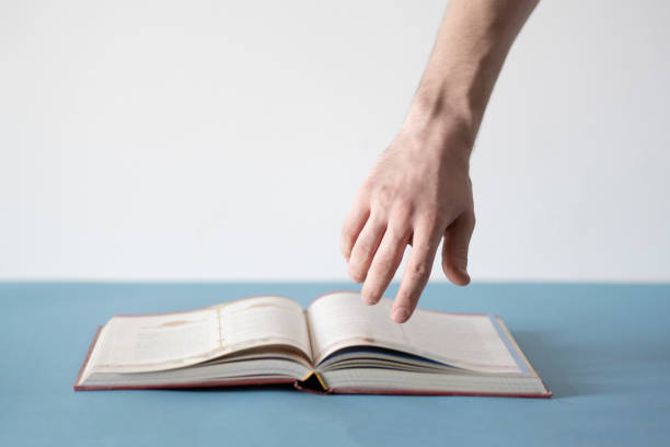 reading book and getting knowledge, hand pointing on the text in book