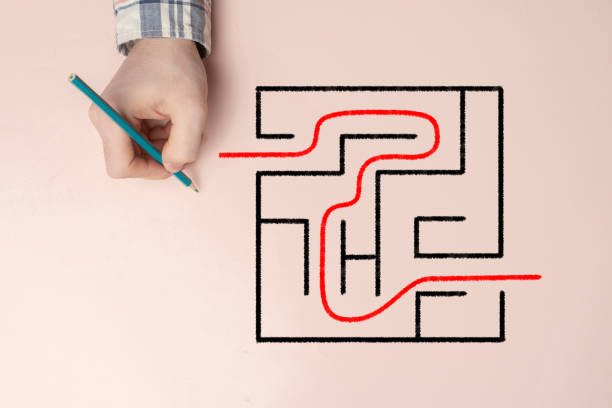 istock overhead view of hand solving a labyrinth task, concept of success 1468247827
