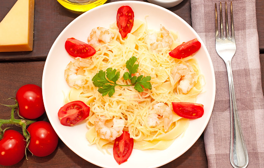 Pasta with shrimps, tomatoes and parmesan cheese. High quality photo