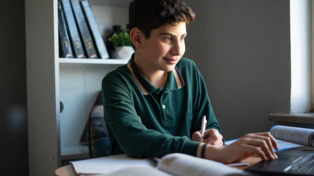 istock Boy is studying with laptop at home 1468248263