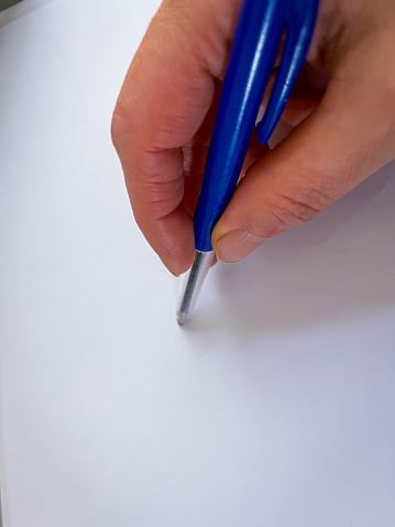 A blue pen on a white paper