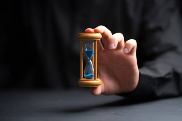 istock time management concept, businessman holding hourglass 1468249974