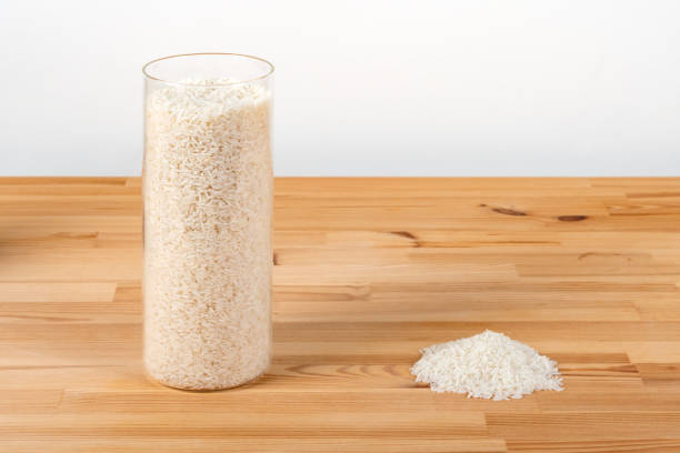 istock Glass storage jar and a heap of rice on a table 1468252568