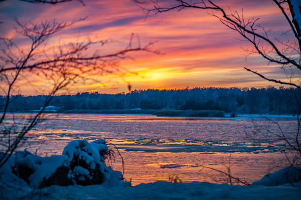 istock Bright  dramatic winter sunset on river with black silhouette trees. 1468255428