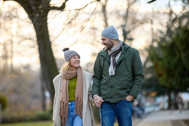 istock Romantic couple enjoying a walk in the park holding hands 1468256471