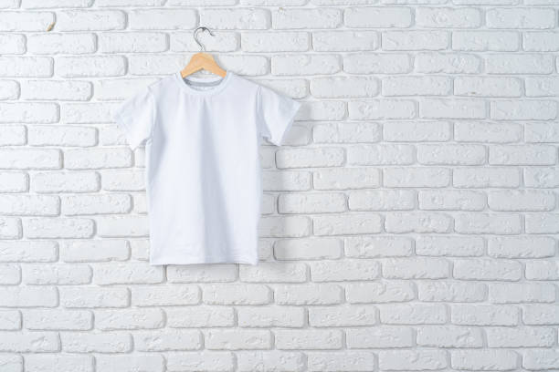 istock White t-shirt hanging on hanger against brick wall 1468257570