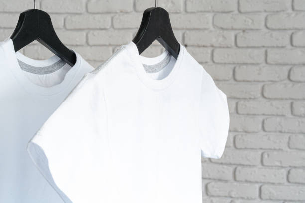 istock White t-shirt hanging on hanger against brick wall 1468257660