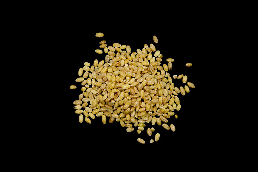 Heap of pearl barley on a black background
