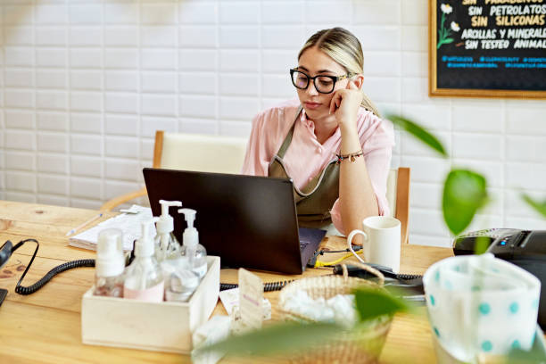 istock Young retail clerk checking inventory on laptop 1468259975