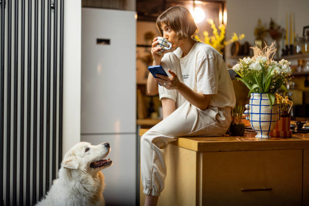 istock Woman with her dog on kitchen during a morning time 1468260682