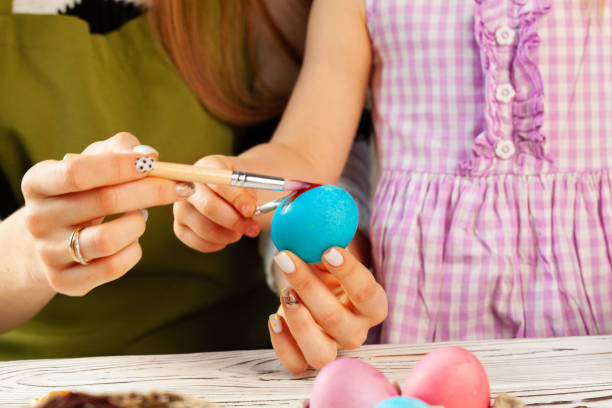 istock Mother and daughter coloring eggs for Easter 1468262185