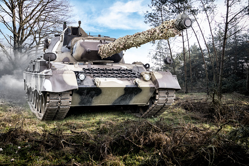 Real armored war tank with camouflage in desert