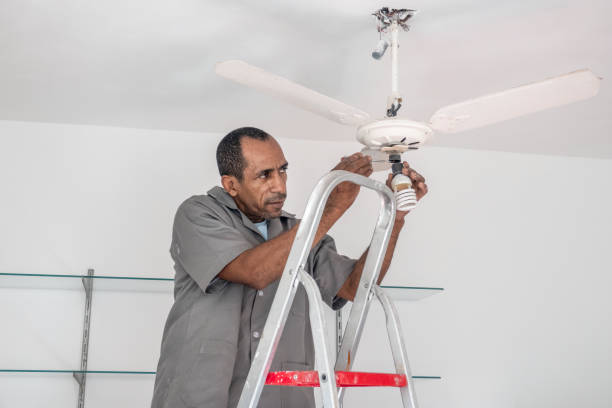 istock Electrician repairs the ceiling fan 1468264064