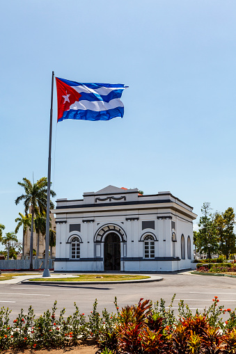 Entrance building of the Santa Ifigenia Cemetery with a big Cuban flag, Santiago de Cuba, Cuba, Caribbean