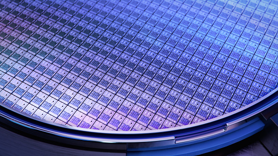 Macro Shot of a Silicon Wafer with Computer Chips during Manufacturing Process at Fab or Foundry. Semicondutor Wafer Texture.