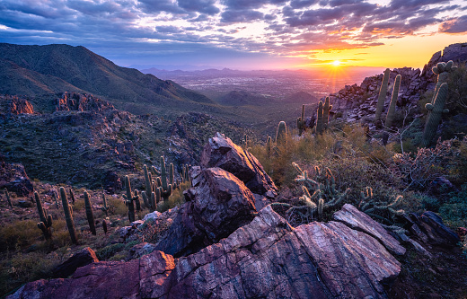 Rugged desert mountain landscape during a beautiful sunset overlooking Scottsdale, AZ from The McDowell Sonoran Preserve