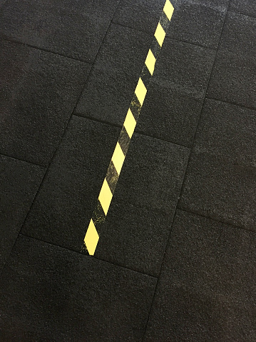 High angle view barricade tape on the rubber flooring