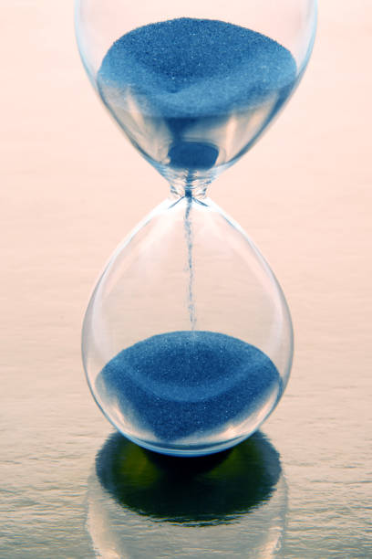 istock hourglass on a golden background. time and minute measurement 1468270251