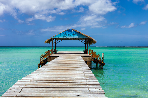 March 10. 2020. Tobago Carribean sea island, Trinidad and Tobago. An iconic thatch roof jetty at the Pigeon Point Heritage Park located in the south west of the island coast of Tobago, popular relax and recreation location on island.