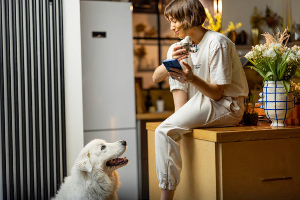 istock Woman with her dog on kitchen during a morning time 1468272742