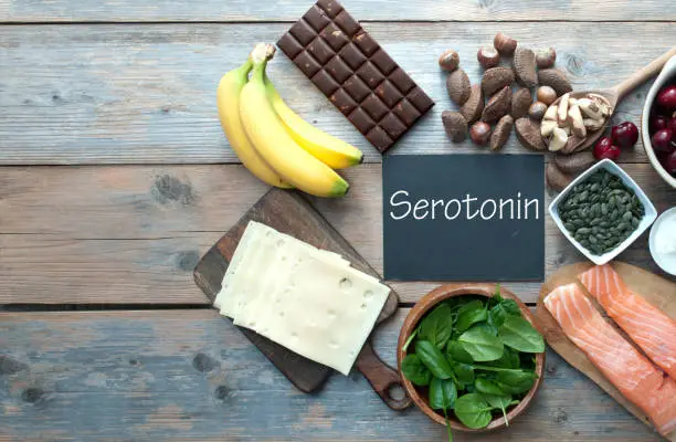 Serotonin, good mood food concept, inlcluding brazil nuts, dark chocolate, cherries and salmon