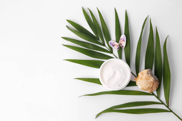 istock Jar of cream, shells, quartz gemstone and palm leaf on white background, flat lay. Space for text 1468273765