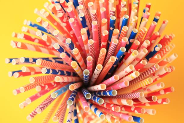 istock Many paper drinking straws on orange background, closeup 1468273960