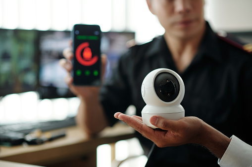 Security guards installing new surveillance equipment in office