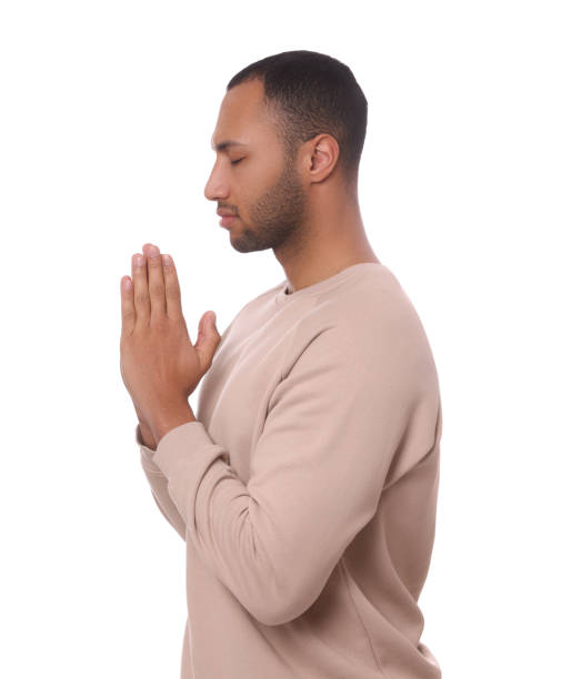 istock African American man with clasped hands praying to God on white background 1468277097